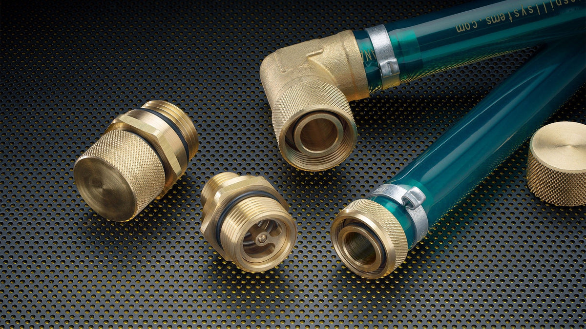Brass oil drain plug fittings and green hose on a textured black surface