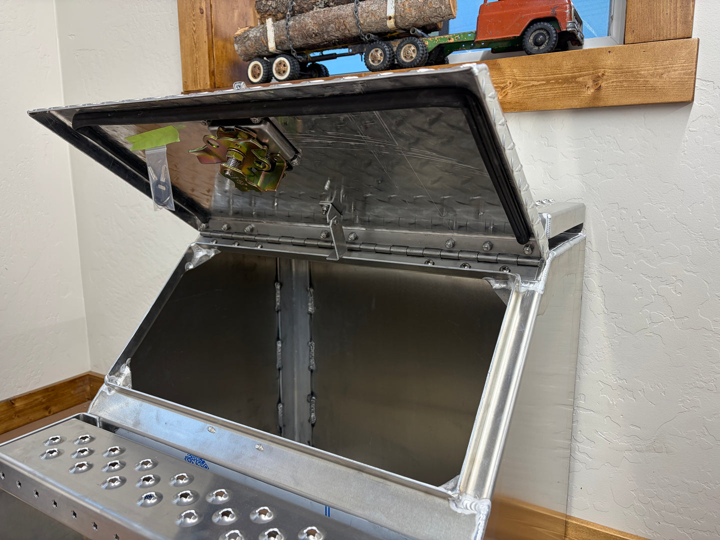 Metal storage unit with open lid in a room setting