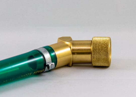 Close-up of a green and gold 45 degree No-Spill drainer on a white background
