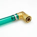 Close-up of a green and gold 90 degree No-Spill drainer on a white background
