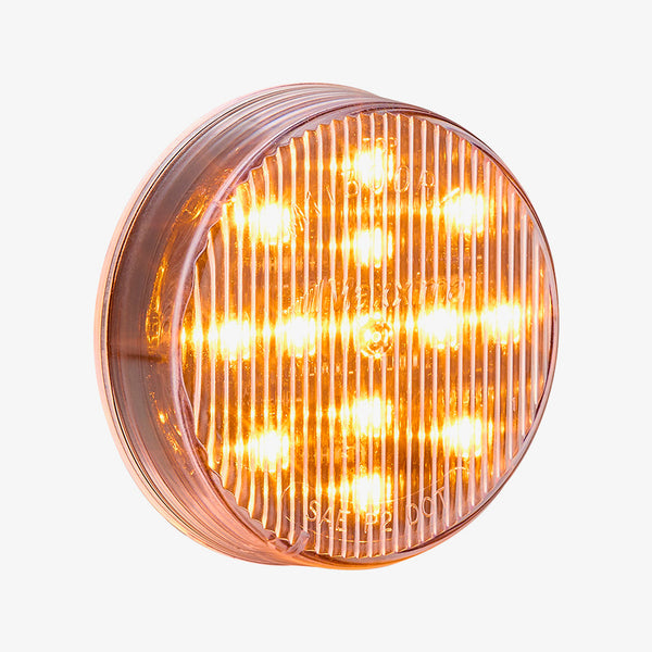 Round amber LED light on a white background